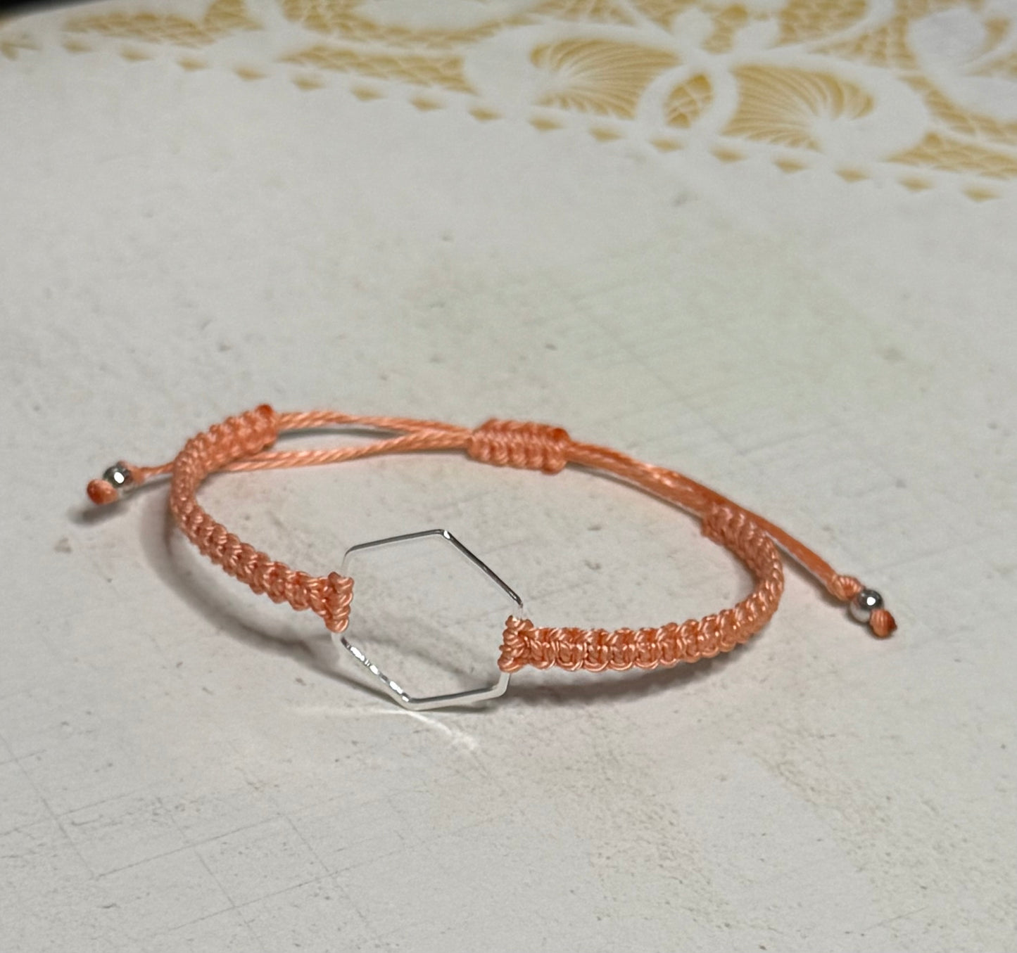 “Coral” macrame knotted bracelet with hexagon charm