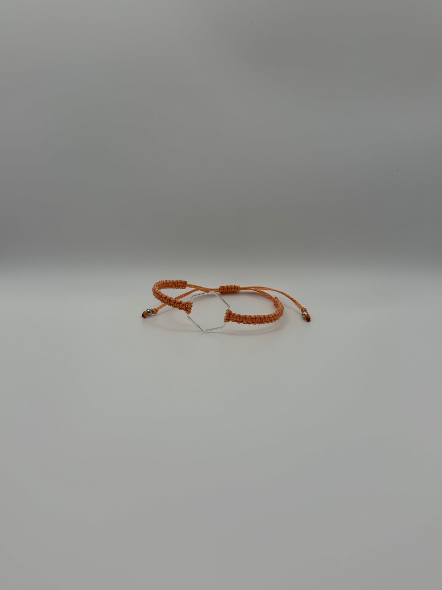 “Coral” macrame knotted bracelet with hexagon charm